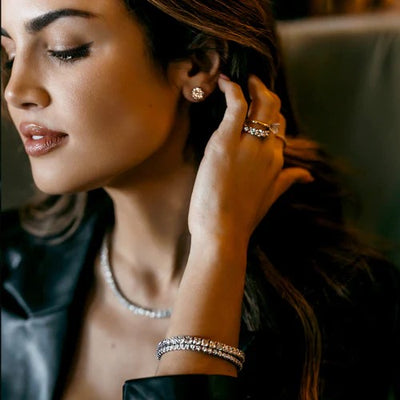 a woman wearing classic diamond jewelry