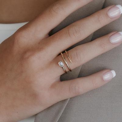 emerald cut diamond and gold spiral ring