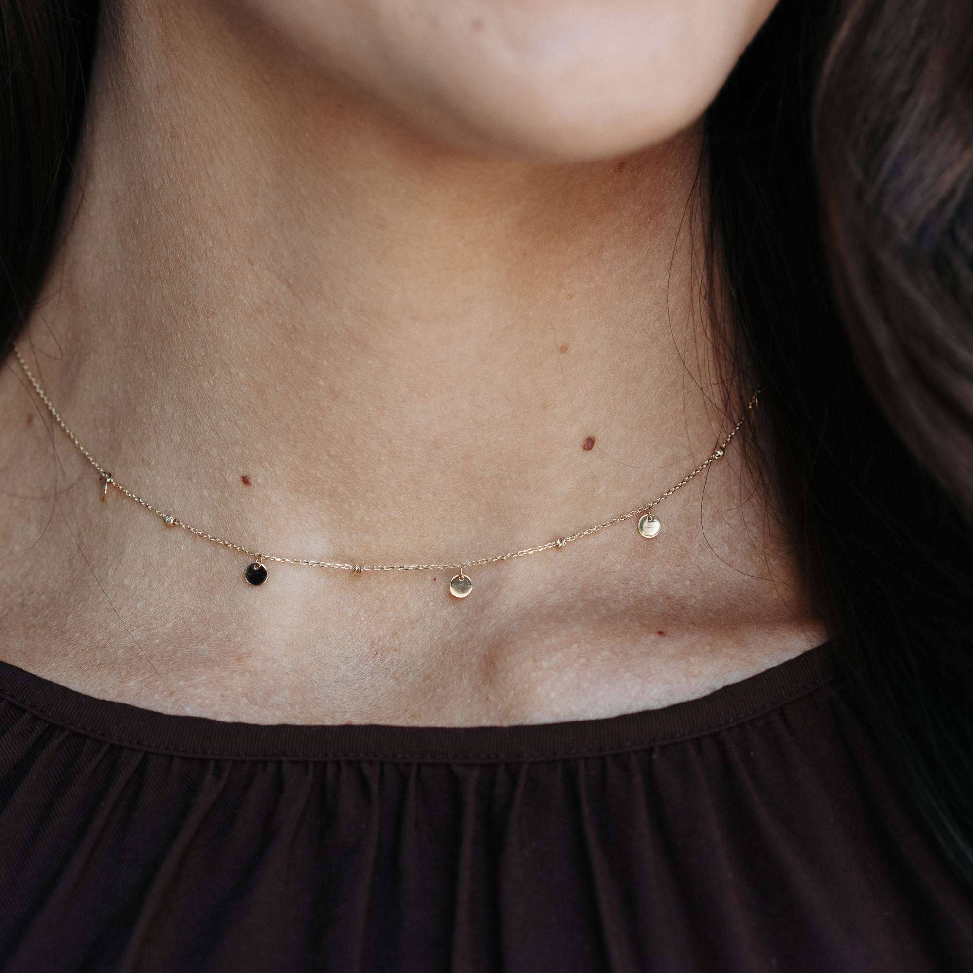 gold bead and dangling disc necklace