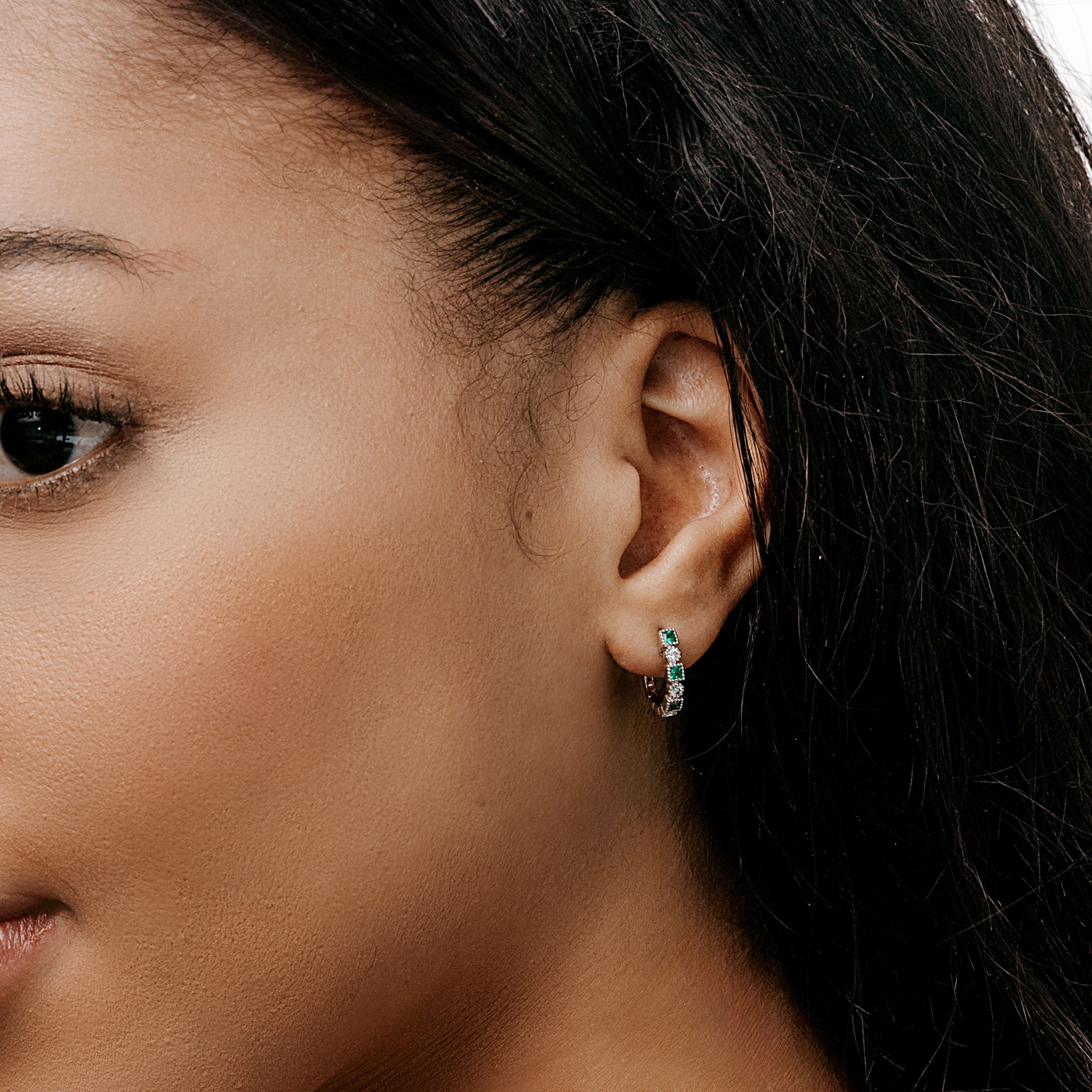 emerald and diamond small hoop earrings with milgrain detail