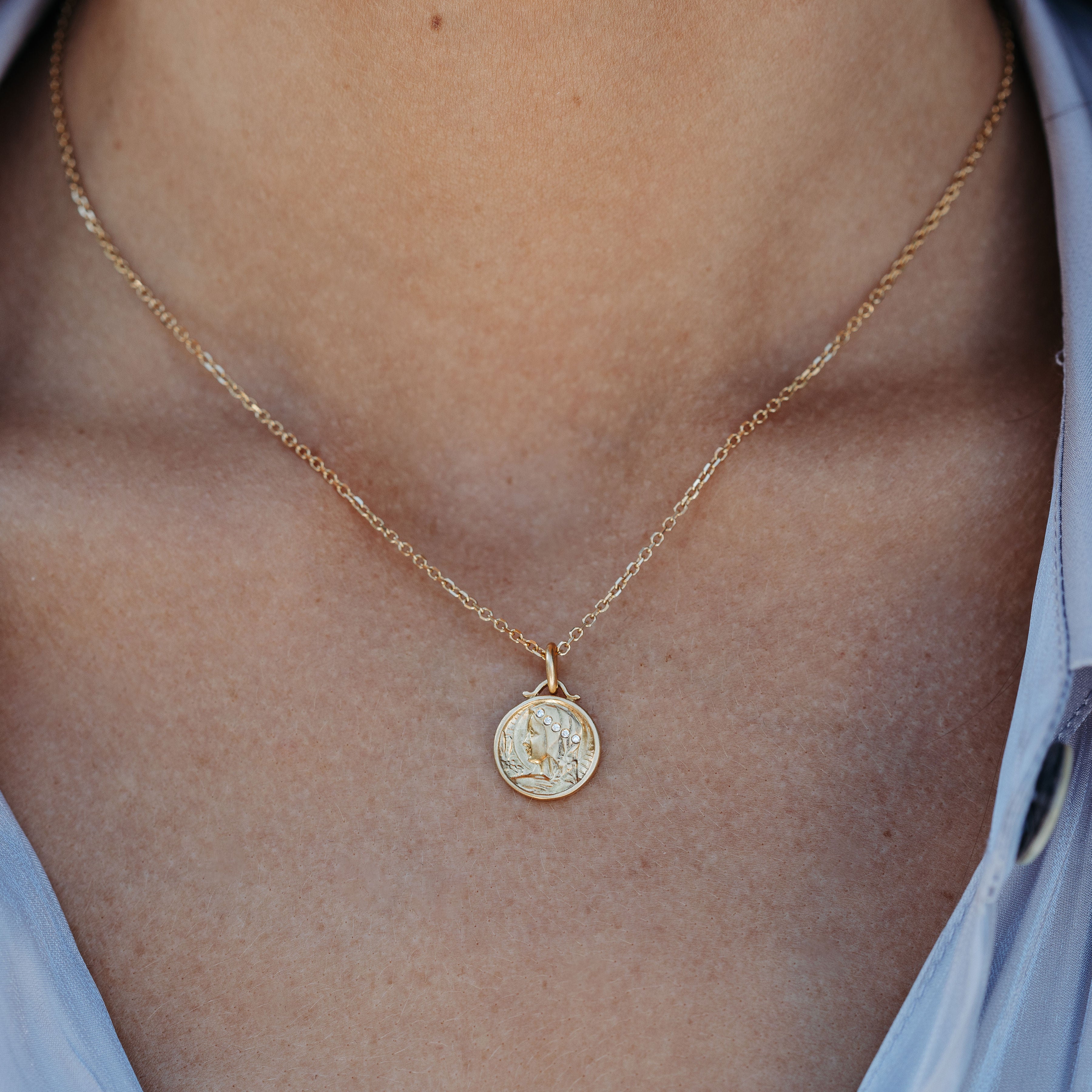 gold and diamond virgin mary with lily medal necklace