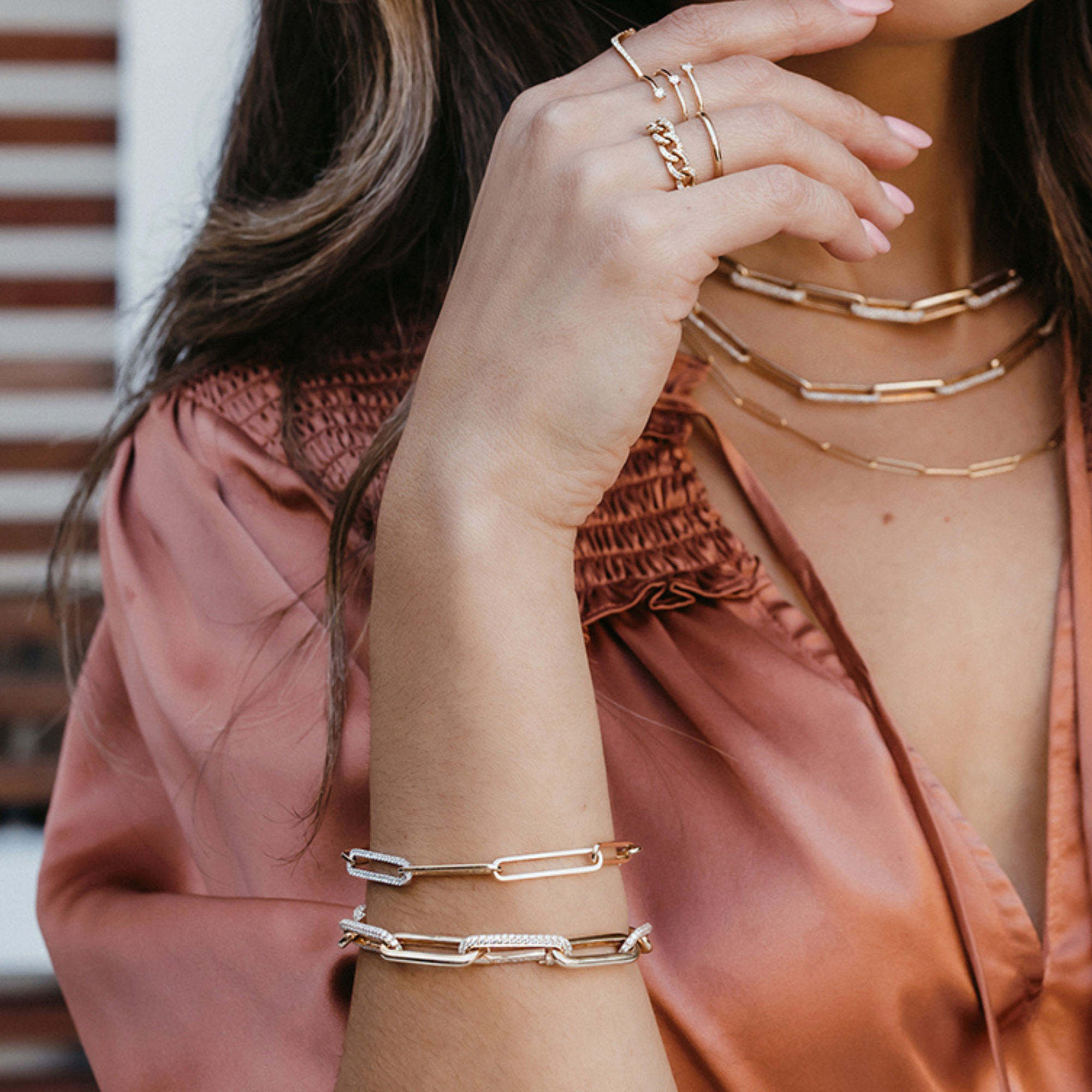 a woman wearing gold paperclip jewelry