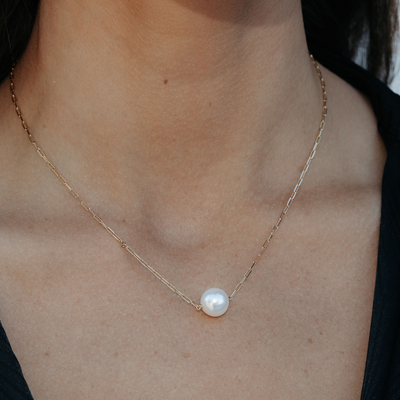 single pearl necklace on a gold paperclip chain