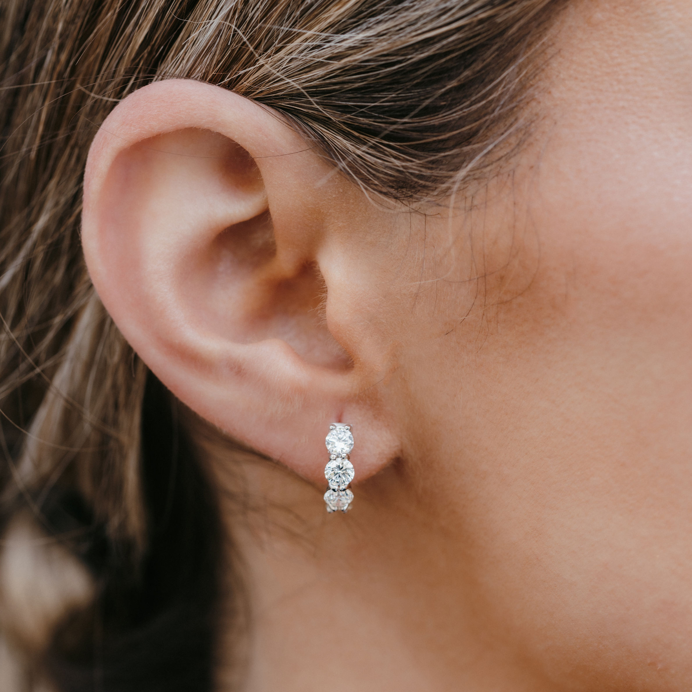 three diamond huggie earrings