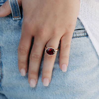 red gemstone and diamond halo ring