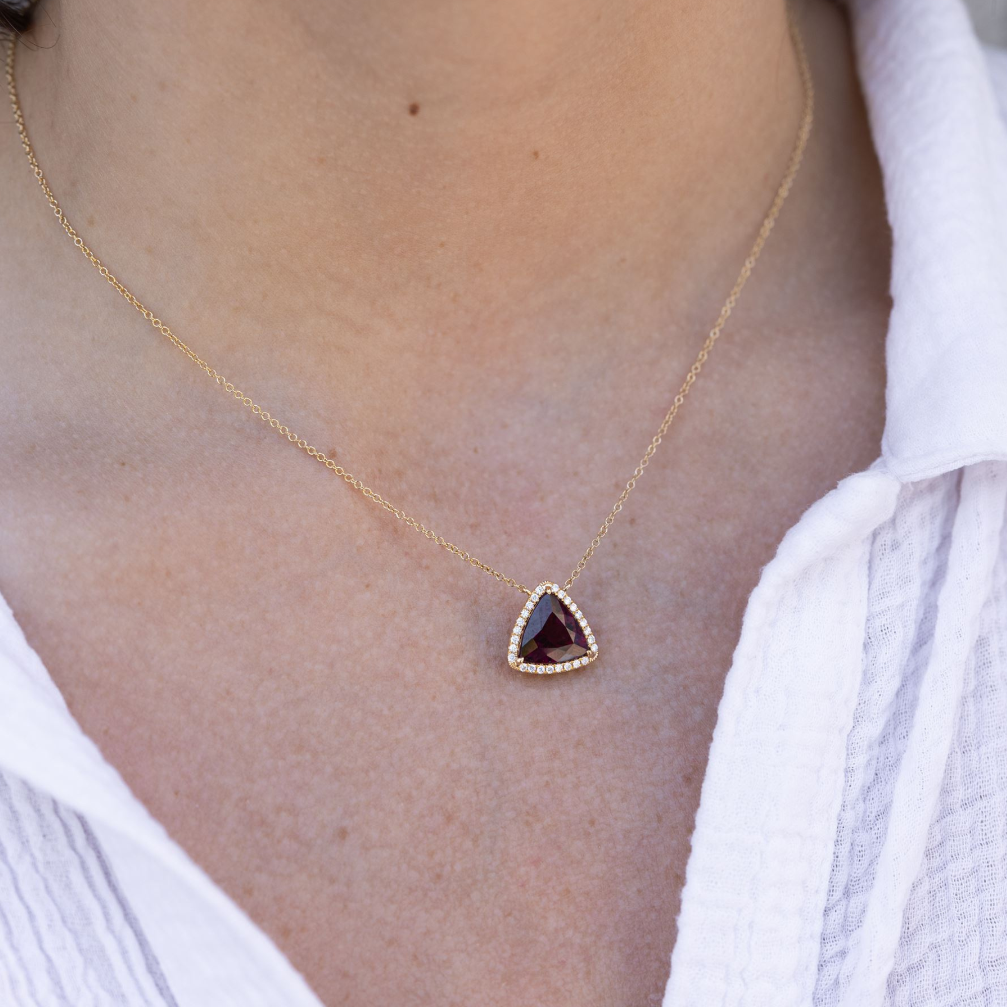 red gemstone and diamond halo necklace