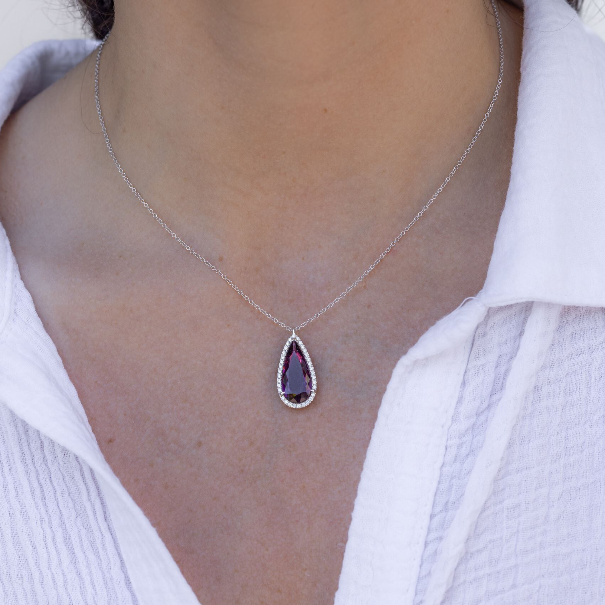 red gemstone and diamond halo necklace