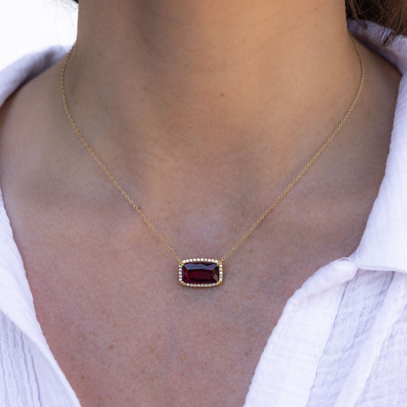 red gemstone and diamond halo necklace