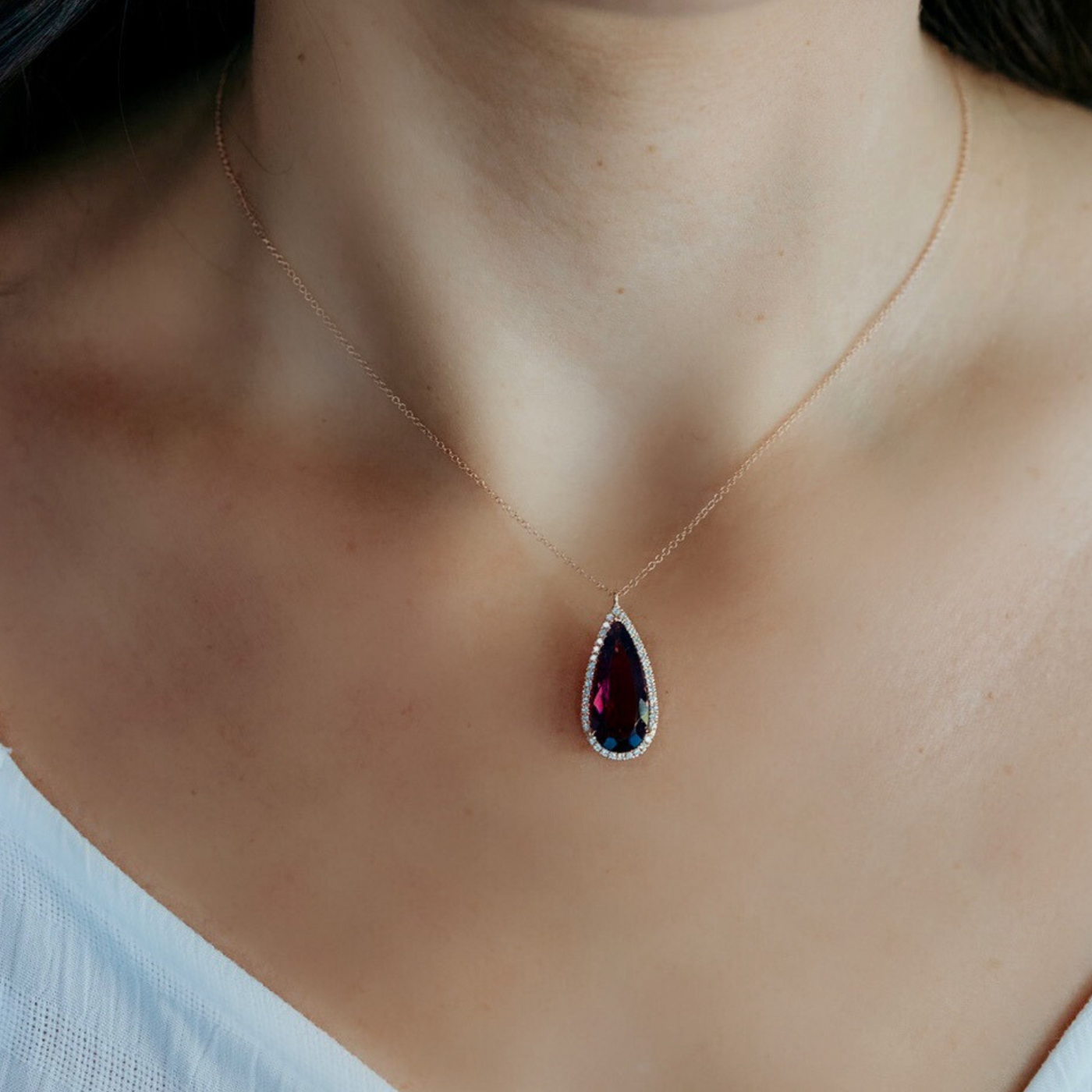red colored gemstone and diamond halo necklace