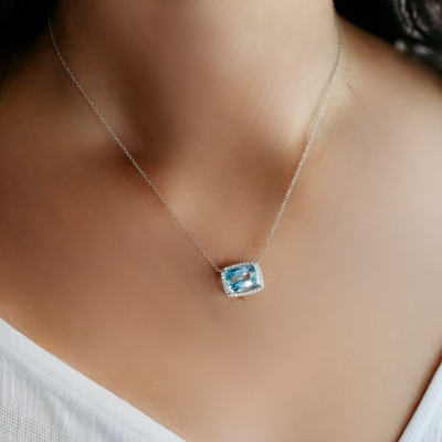 blue gemstone and diamond halo necklace