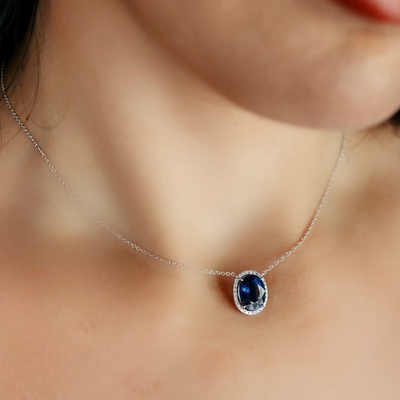 Oval sapphire and diamond halo necklace