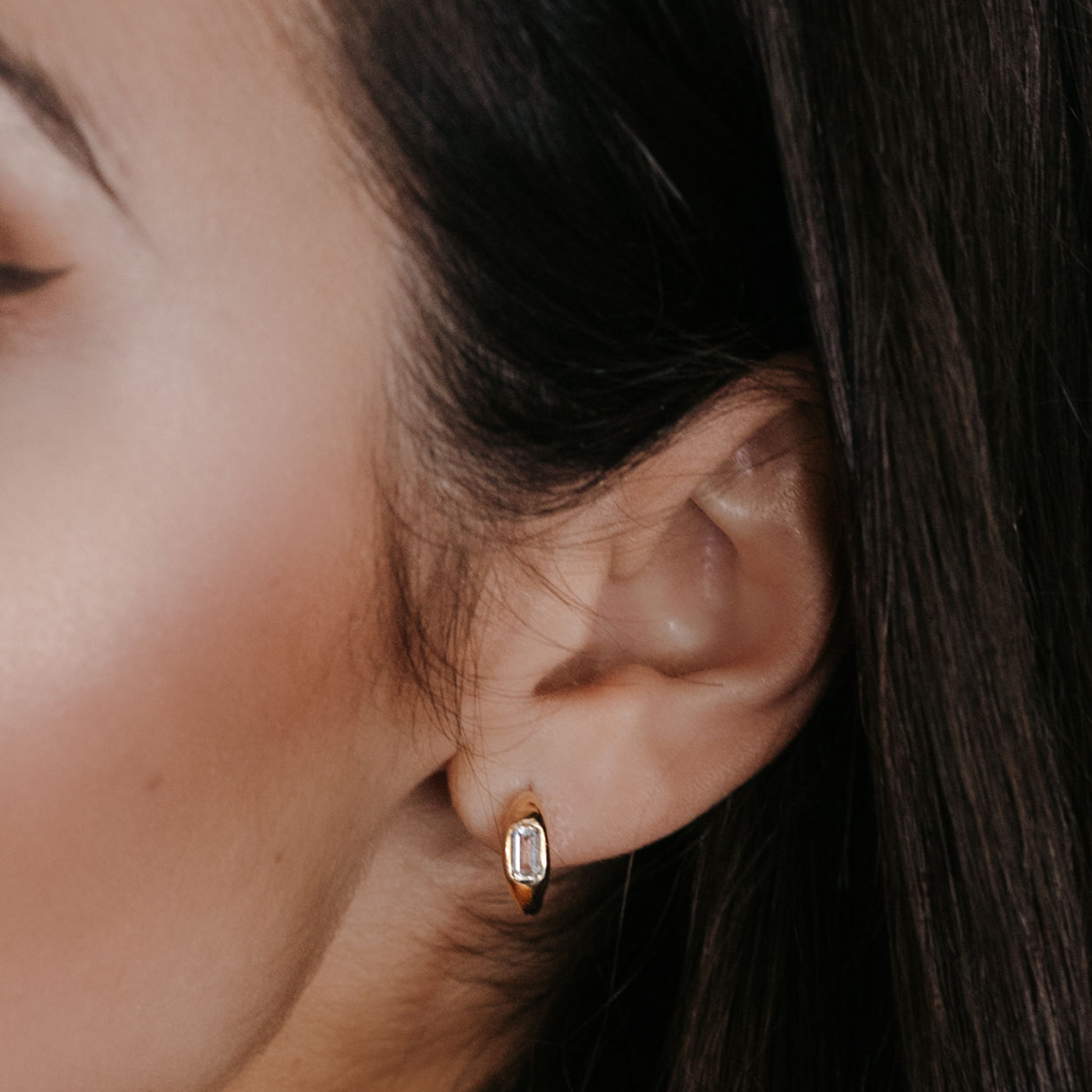 white topaz and gold huggie earrings